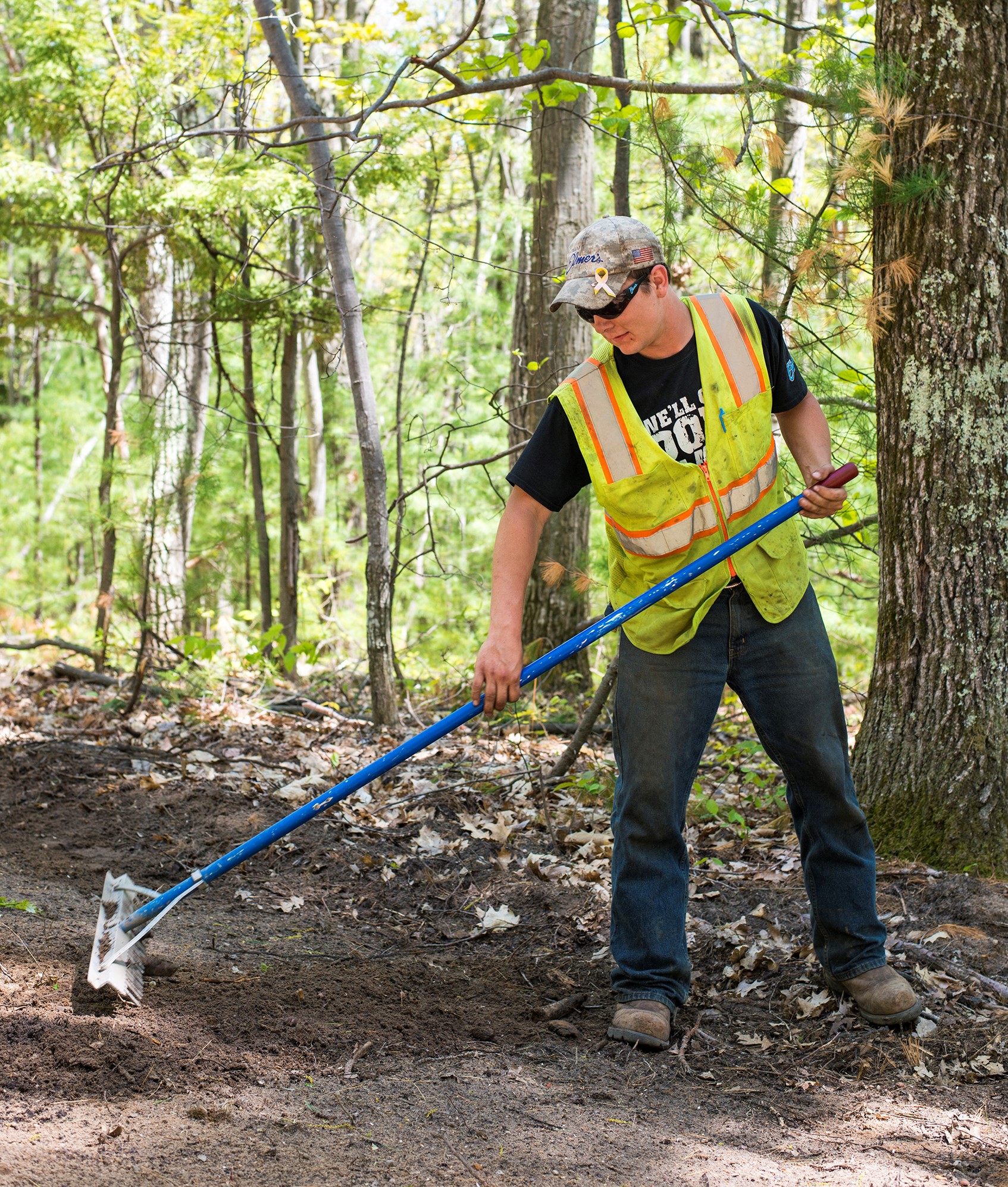 Construction worker raking on a restoration jobsite